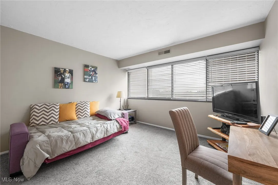 Bedroom featuring carpet floors and baseboards