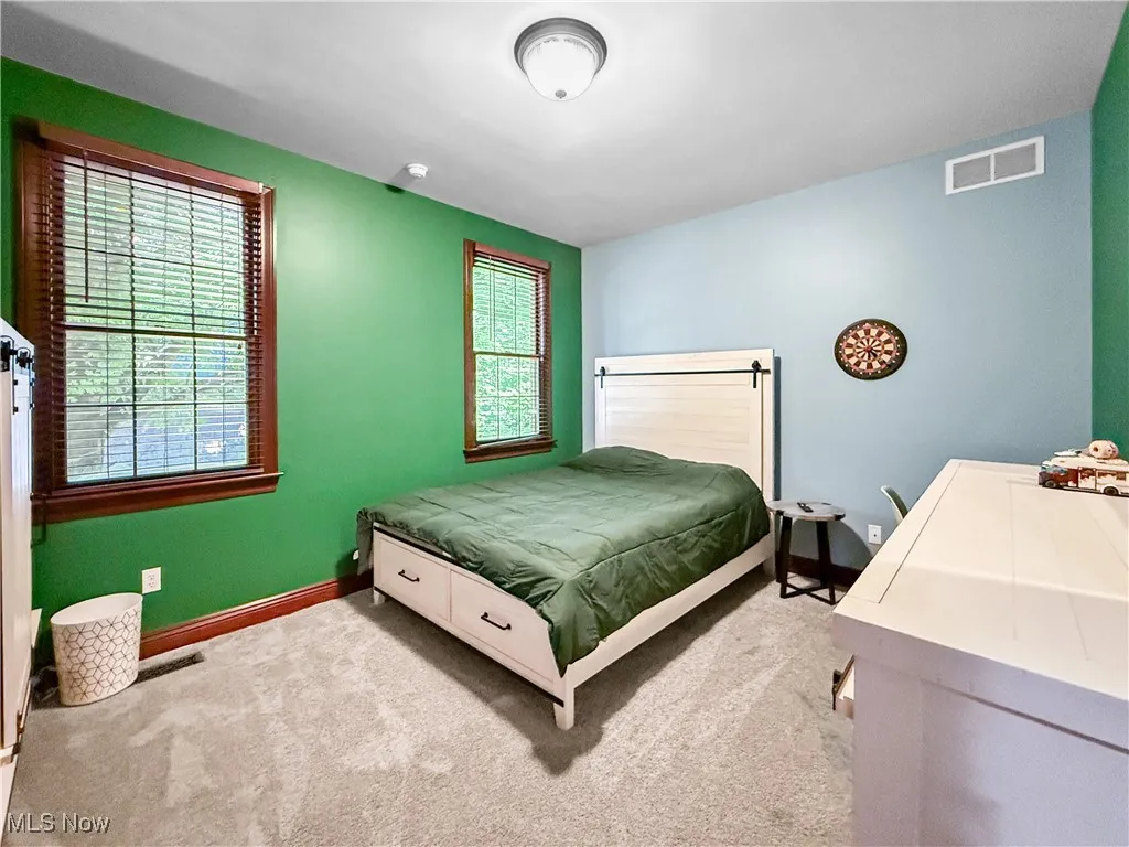 Bedroom with light colored carpet