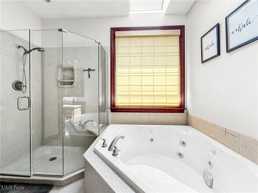 Bathroom featuring a stall shower and a jetted tub