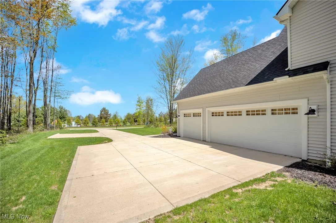 View of side of property and a 3 car attached garage