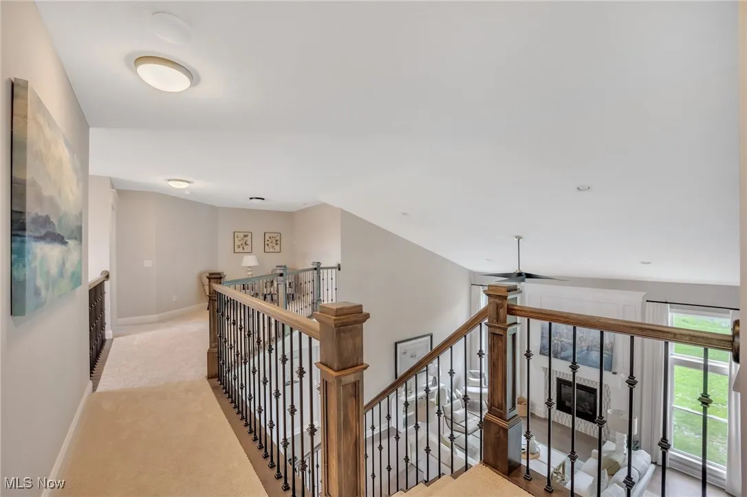 Staircase to 2nd floor loft area with craftsman newel posts and metal spindles