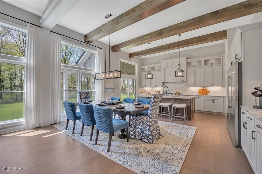 12' tall Kitchen featuring glass insert cabinets, a breakfast bar, tile backsplash, hardwood flooring, and leather finished granite counters