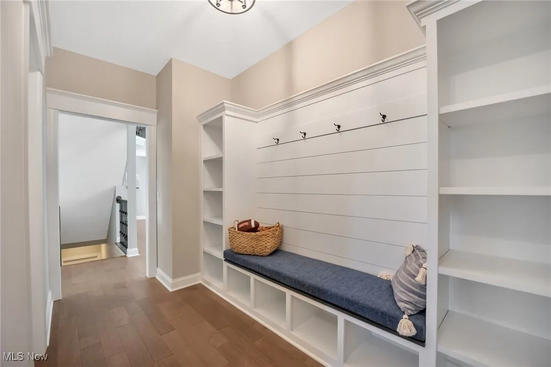 Mudroom featuring built in cubbies and hardwood flooring
