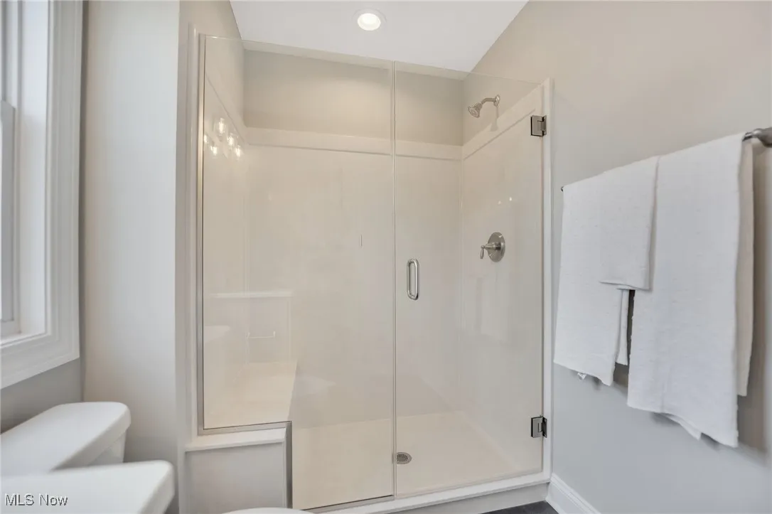 Full bathroom featuring a cultured marble stall shower and recessed lighting