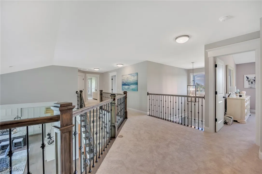Staircase to 2nd floor loft area with craftsman newel posts and metal spindles