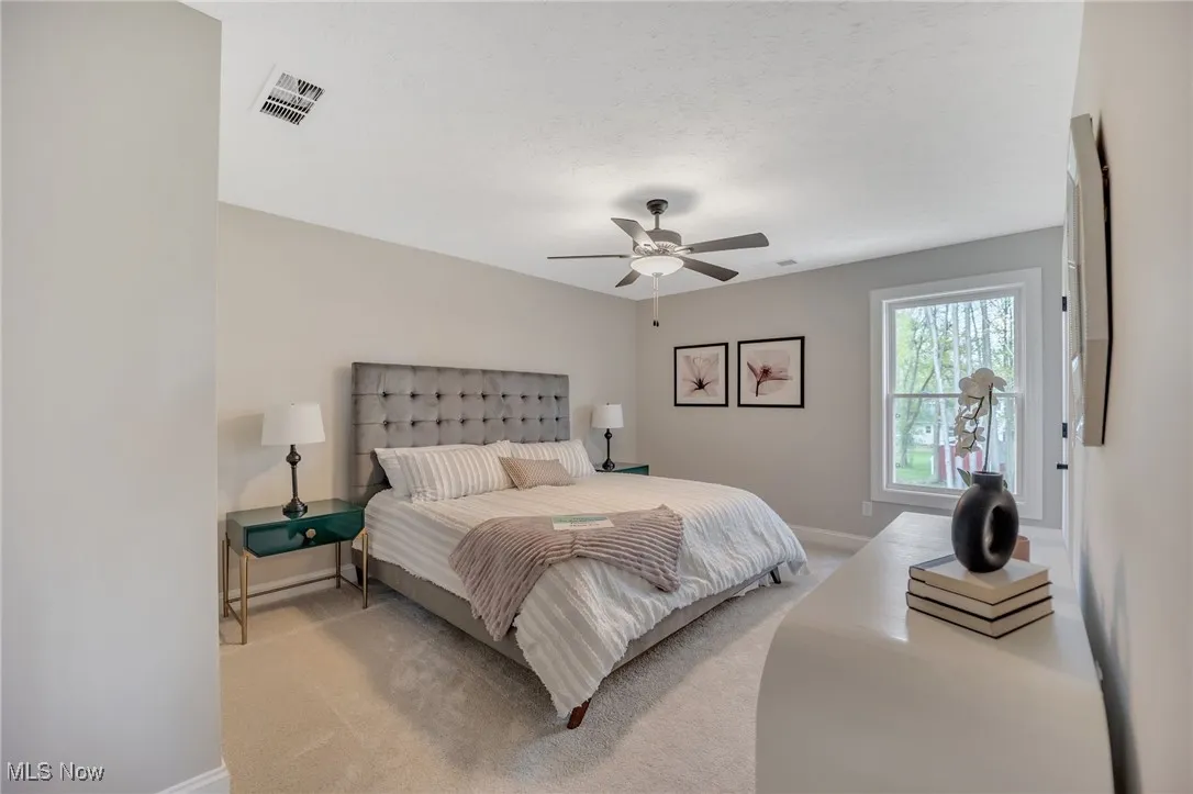 Carpeted bedroom with baseboards and ceiling fan