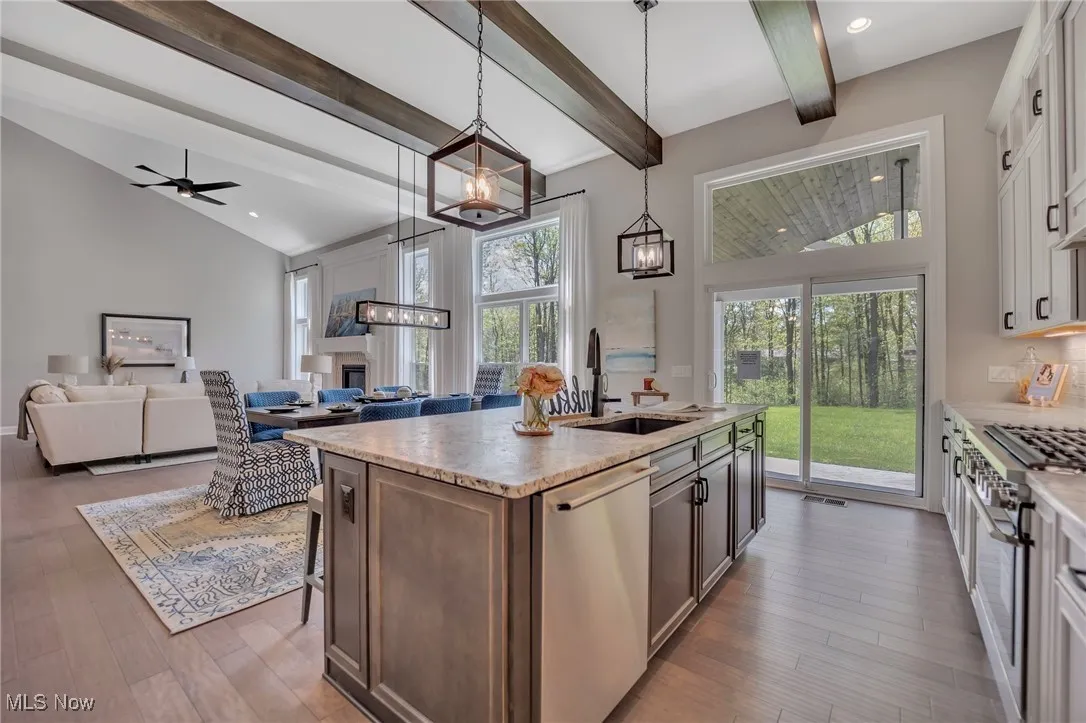 12' tall Kitchen featuring glass insert cabinets, large island, tile backsplash, hardwood flooring, stainless steel appliances and leather finished granite counters