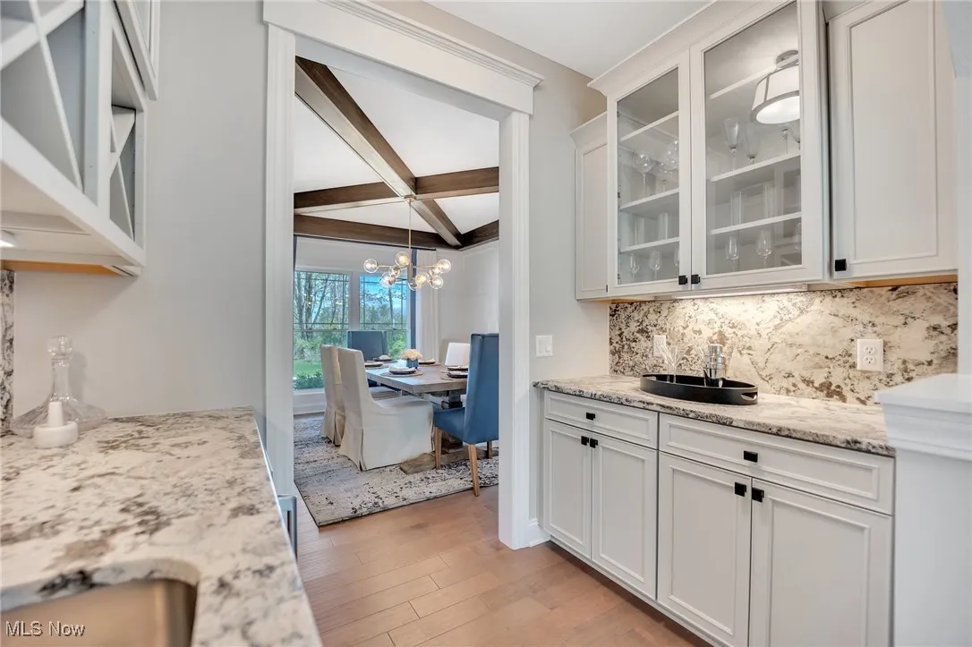 Butler Pantry with sink, granite counters & backsplash, glass insert cabinets & beverage cooler