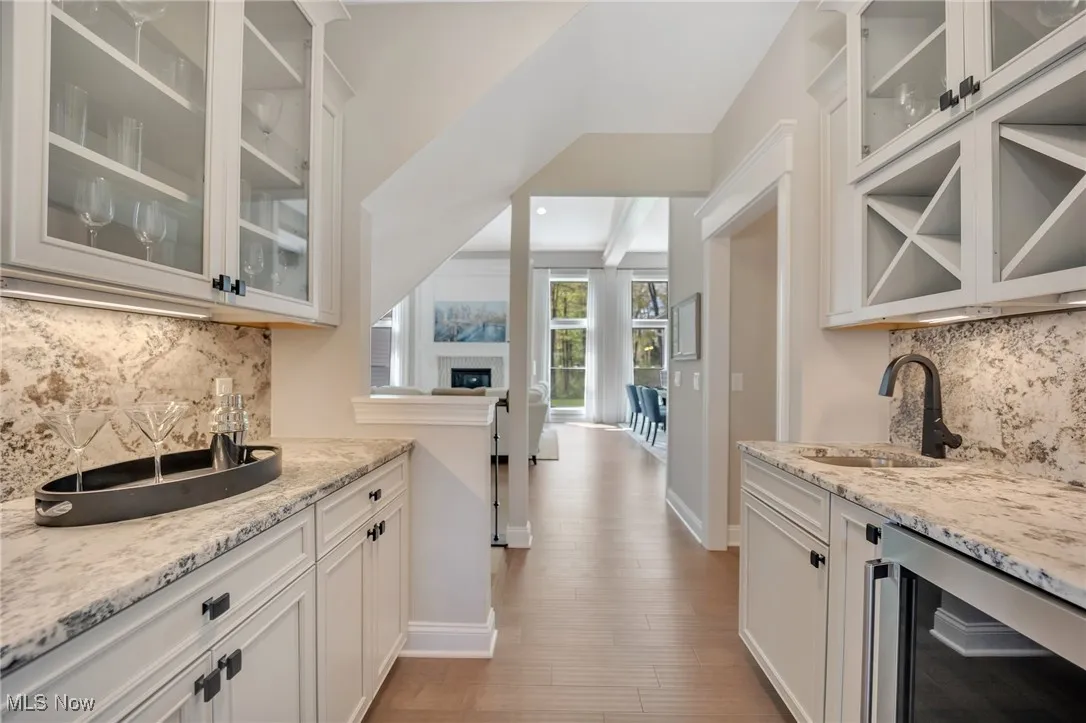 Butler Pantry with sink, granite counters & backsplash, glass insert cabinets & beverage cooler