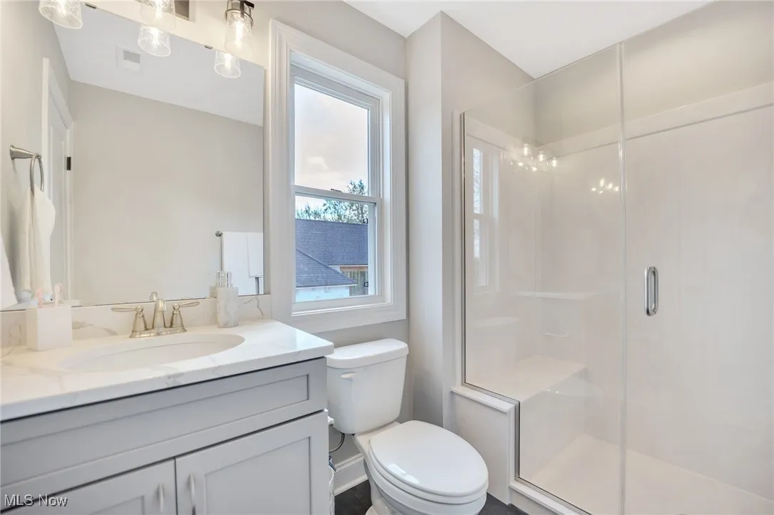 Bathroom featuring vanity and a cultured marble stall shower