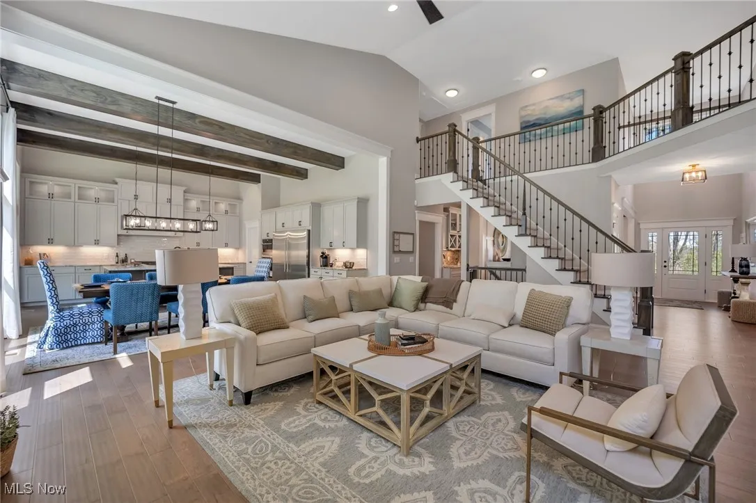 Great room with hardwood flooring, vaulted ceiling and ceiling fan