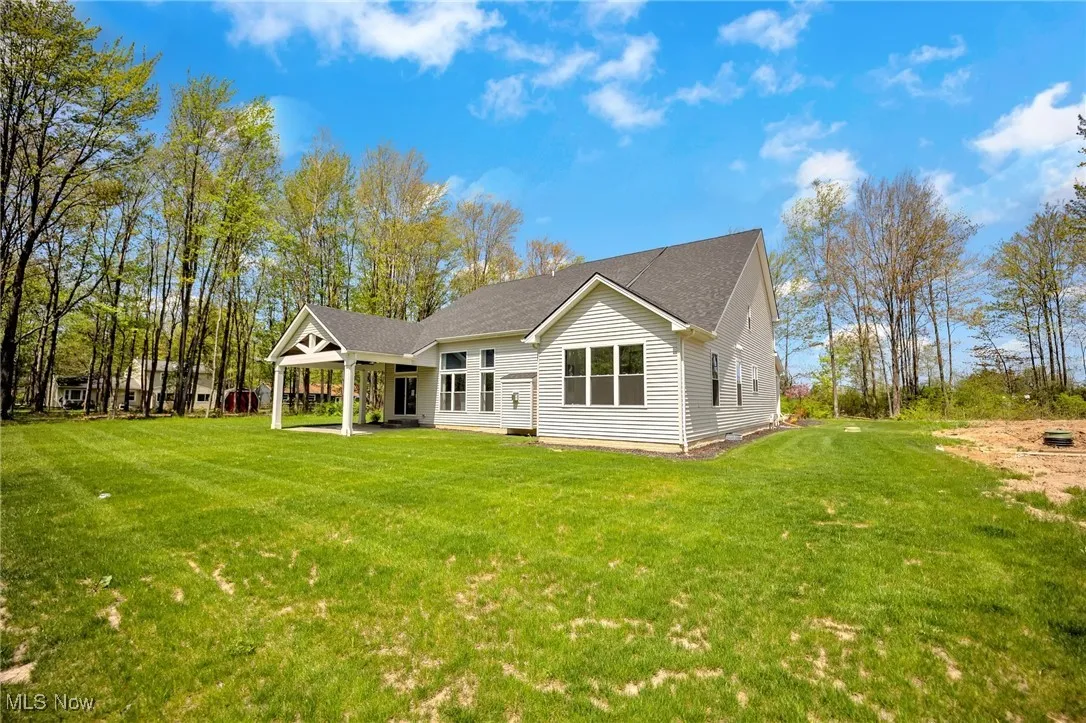 Rear view of property with a covered stamped concrete patio.
