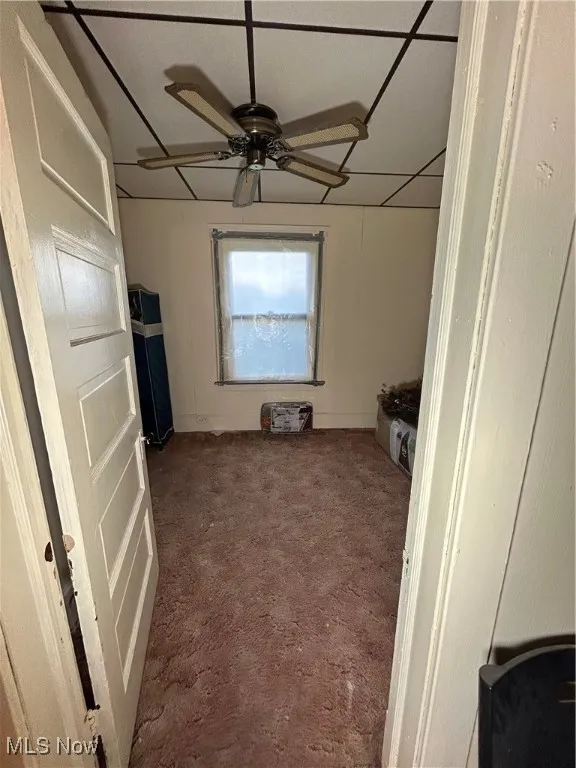 Unfurnished bedroom featuring ceiling fan and baseboards