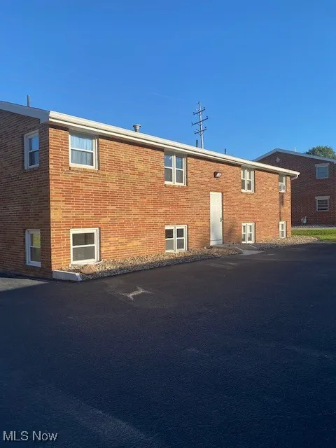 View of front of home featuring brick siding