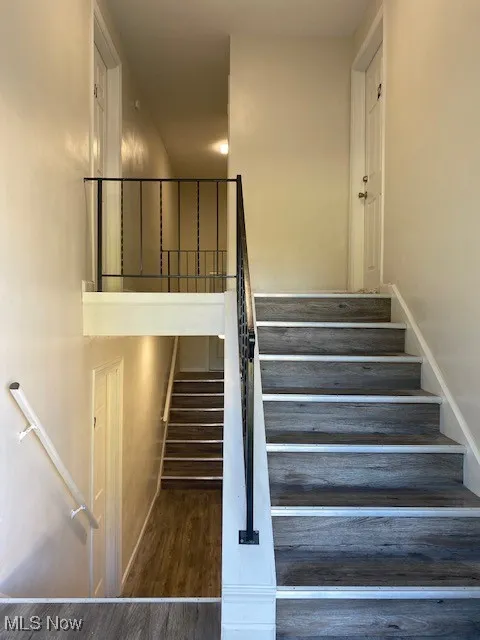 Stairs featuring wood finished floors