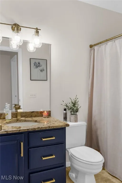 Full Bathroom featuring granite,vanity and toilet