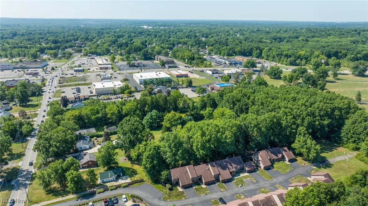 Aerial overview of property's location with a heavily wooded area