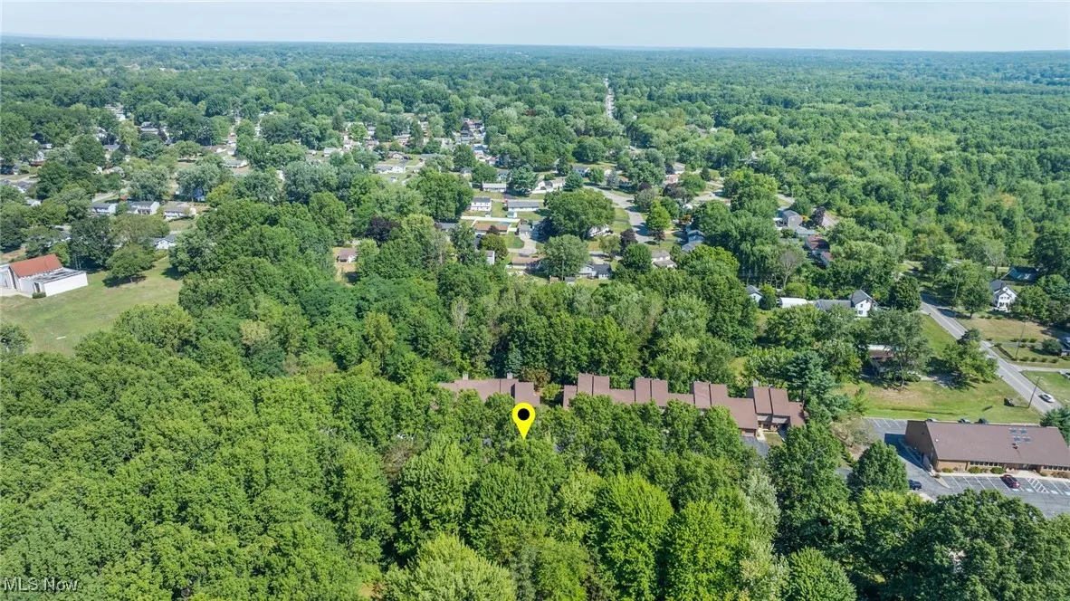 Aerial view of property's location with a heavily wooded area