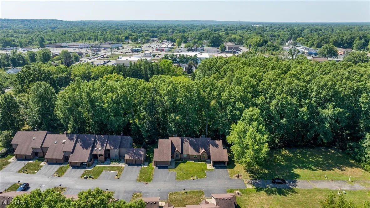 Aerial view of property's location featuring a heavily wooded area