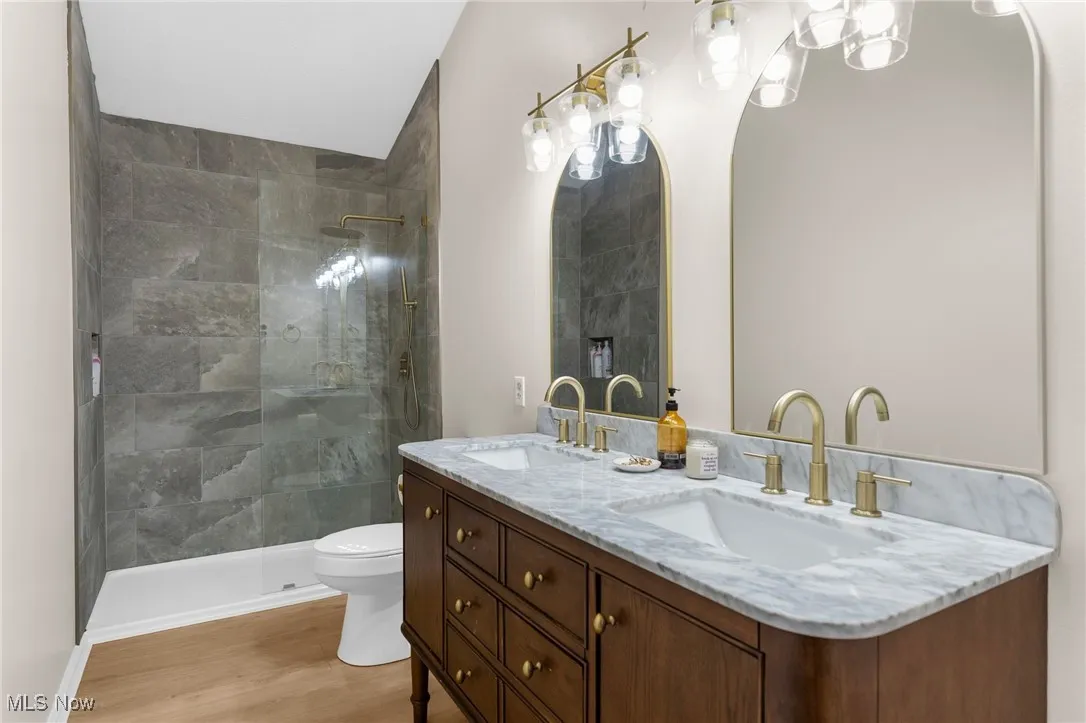 updated remodeled,Full bath with double vanity, walk in shower, and light wood finished floors