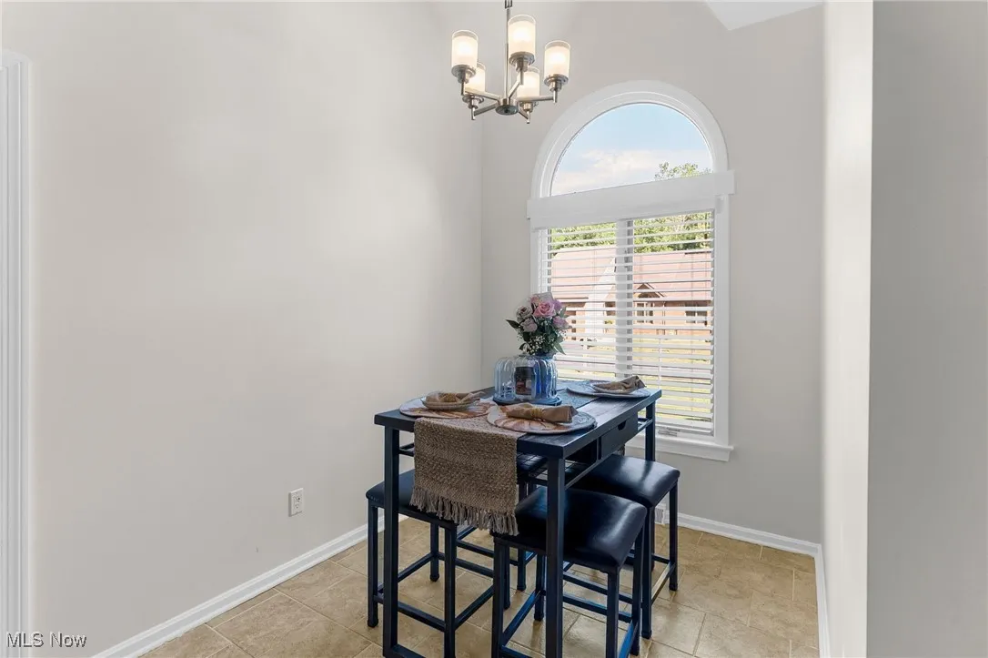 Dining space with a chandelier and light tile patterned floors
