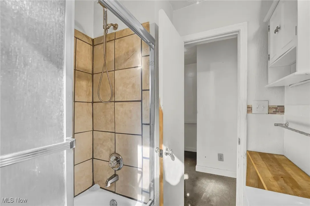 Full bath featuring shower / washtub combination
