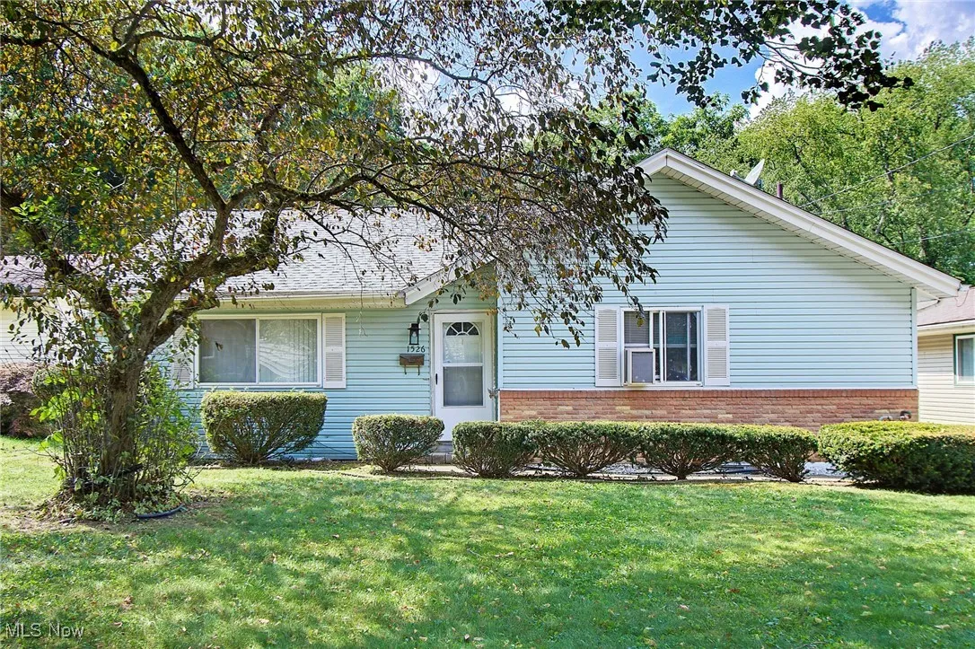 View of front of house featuring brick siding and a front yard