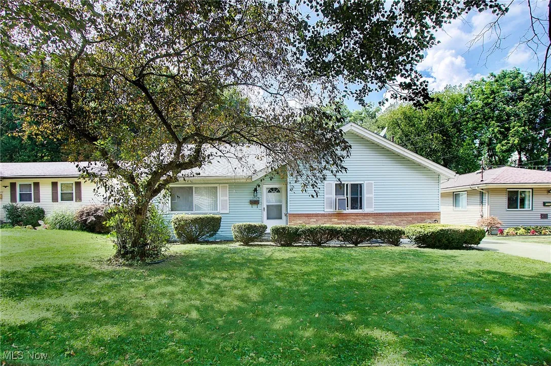 Single story home with brick siding and a front lawn