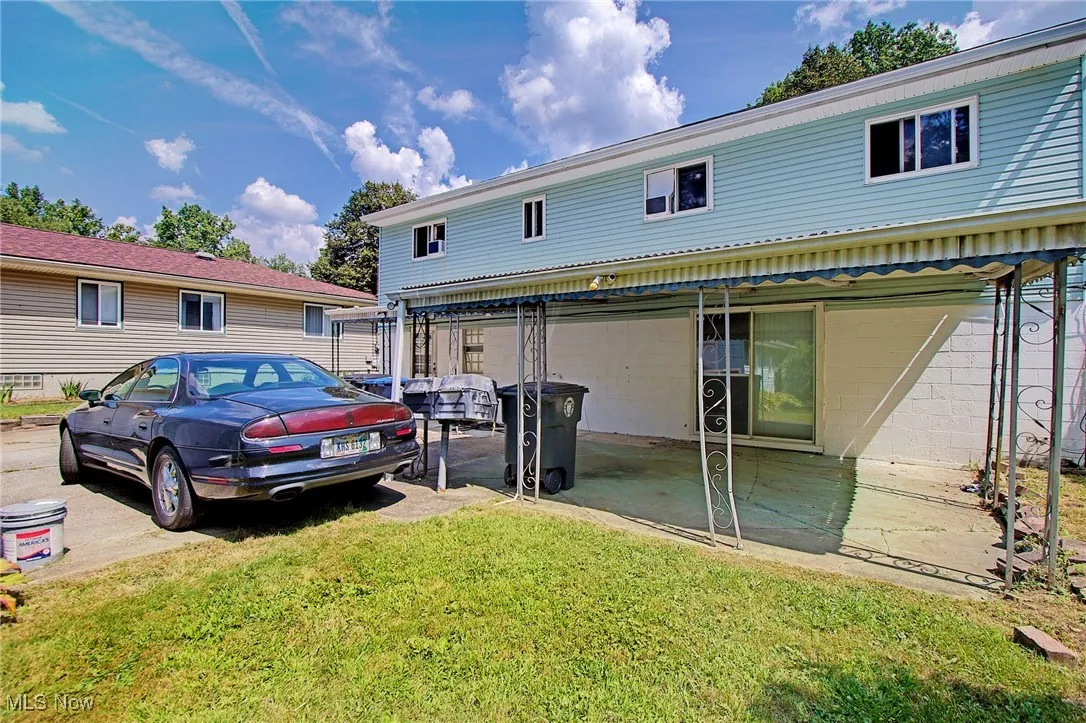 Back of house with a yard