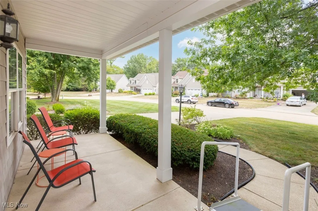 Porch featuring a residential view and a lawn