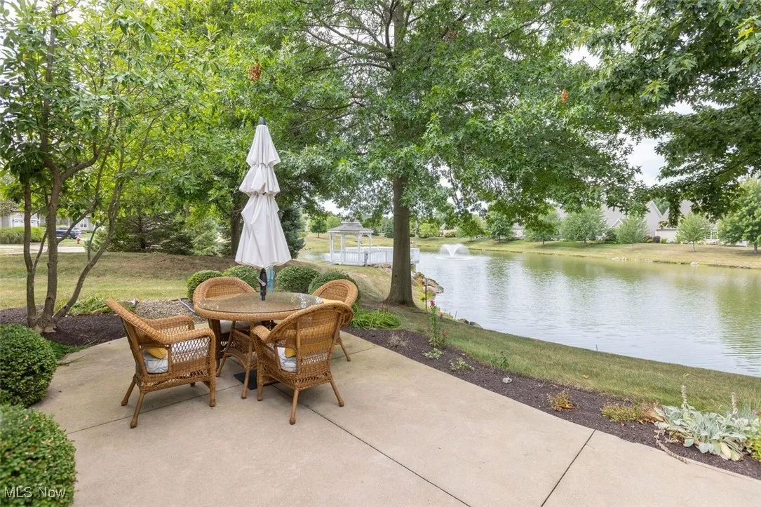 View of patio featuring a water view and outdoor dining area