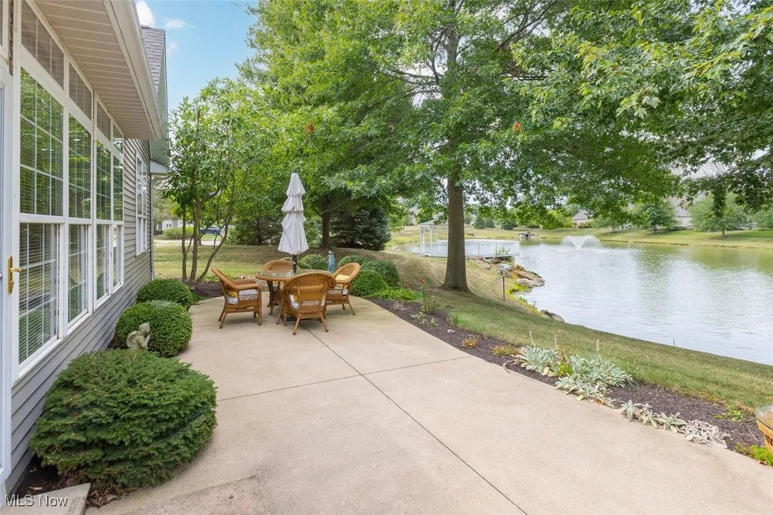 View of patio with a water view and outdoor dining space