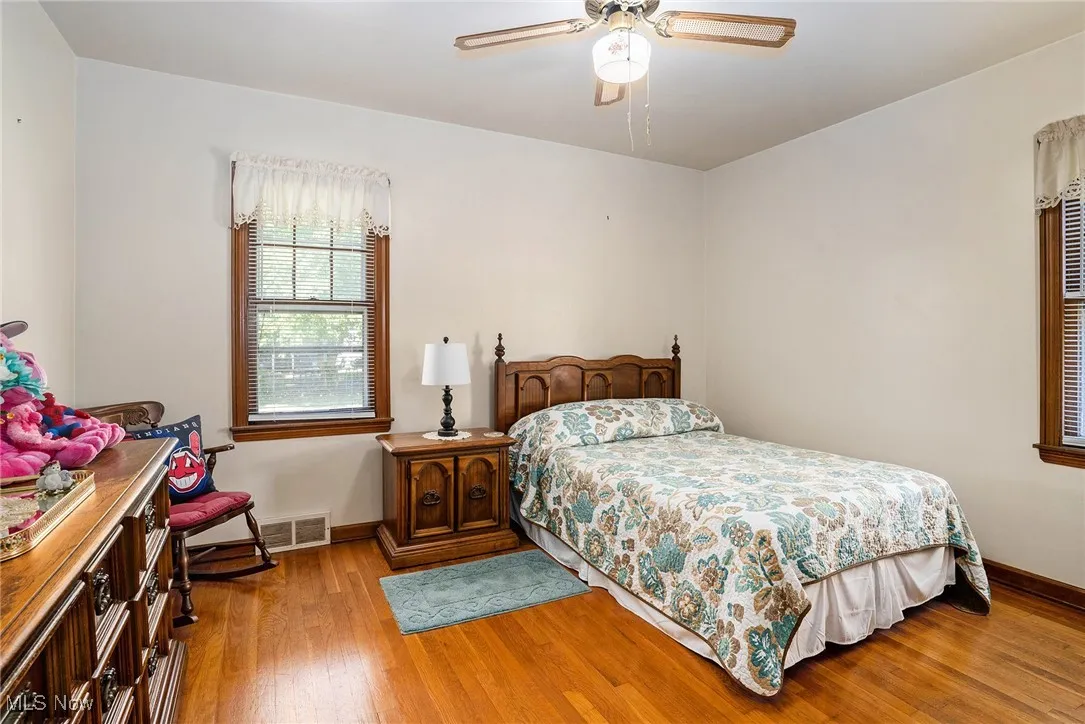 Bedroom featuring wood finished floors and a ceiling fan