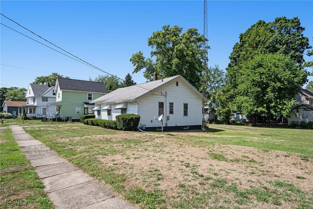 View of side of property featuring a yard