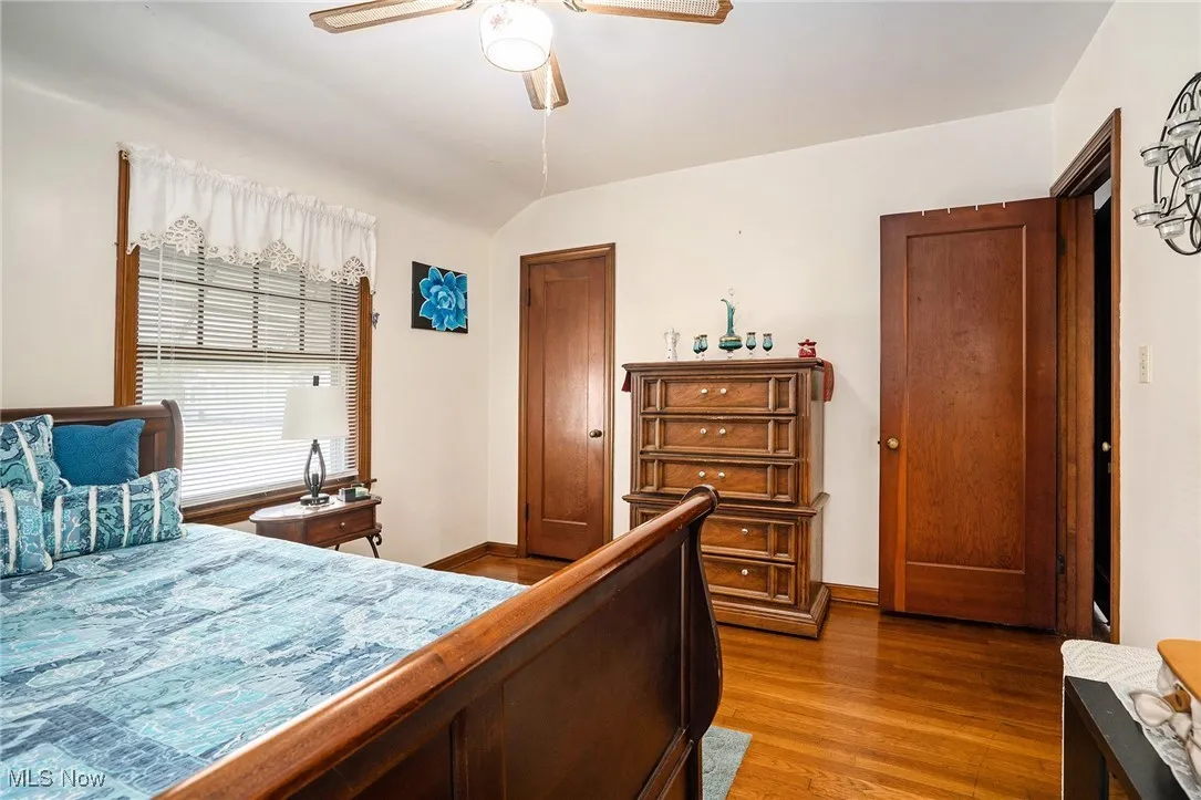 Bedroom featuring wood finished floors, a ceiling fan, and vaulted ceiling