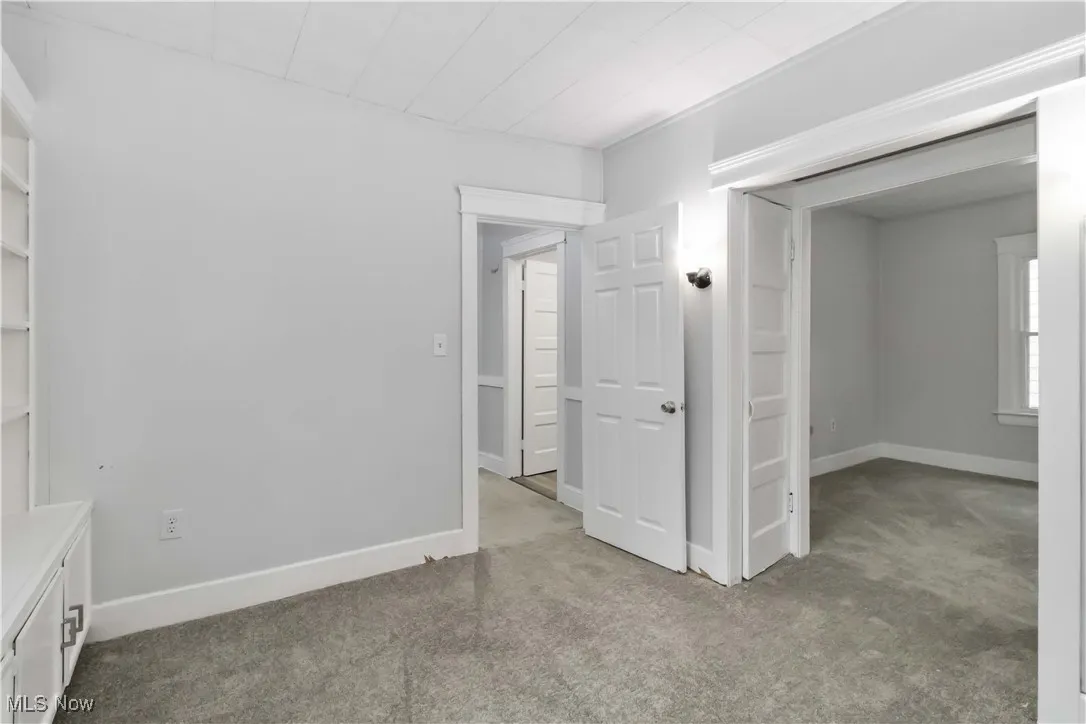Unfurnished bedroom featuring light carpet