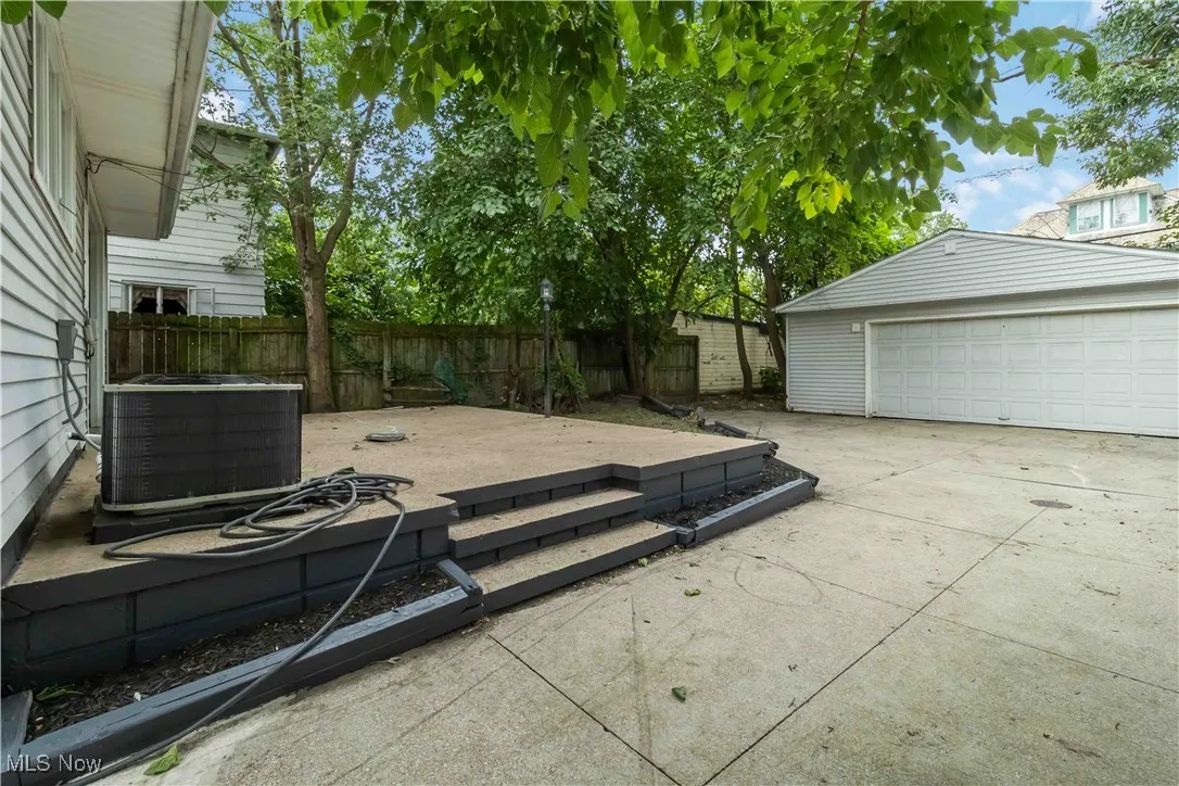 View of patio featuring an outbuilding and a garage