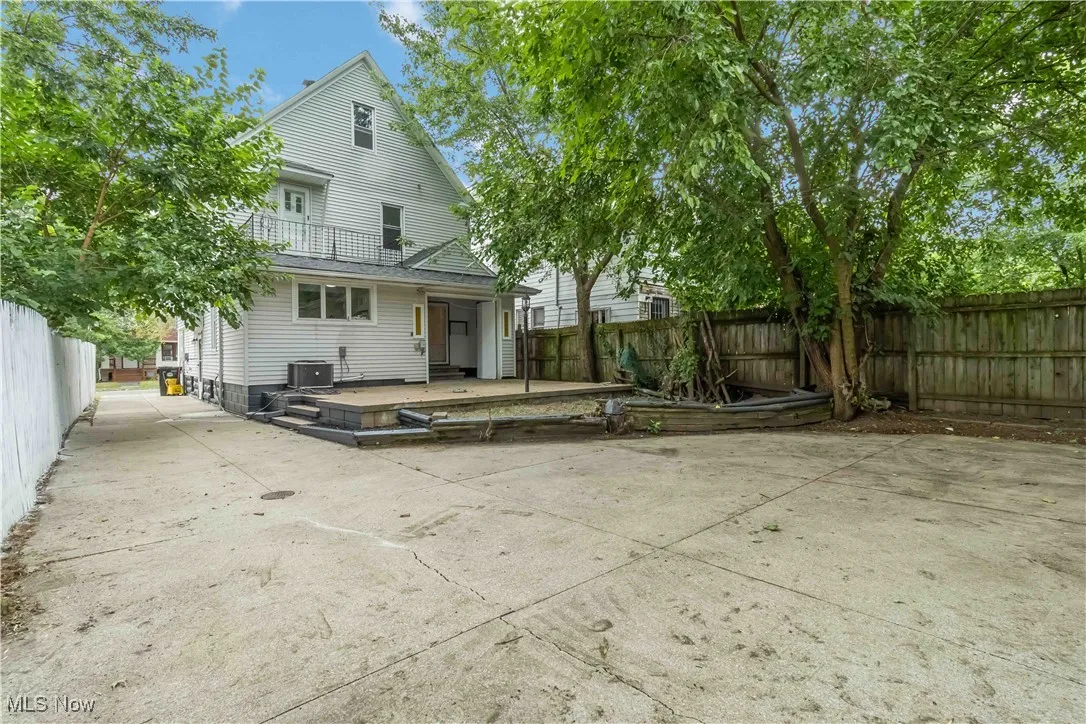 Back of property with a fenced backyard and a wooden deck