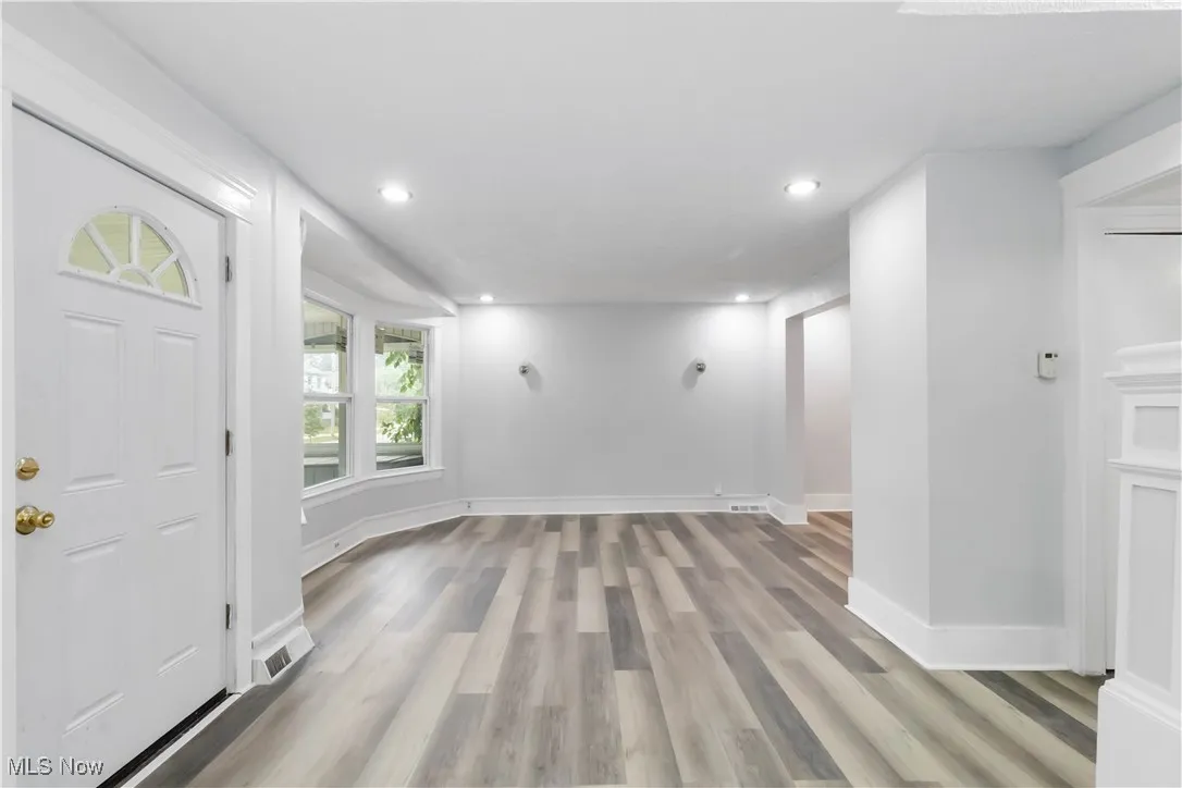 Entryway with light wood-style floors and recessed lighting