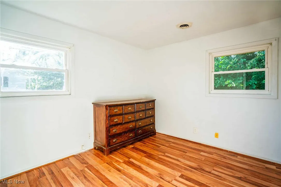 Bedroom with light wood-type flooring and baseboards