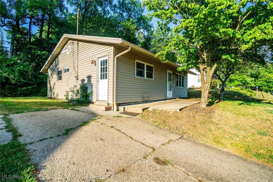 View of front of house featuring a front lawn and a patio