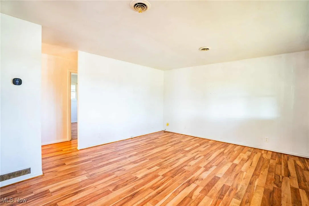 Unfurnished room featuring light wood-style floors and baseboards