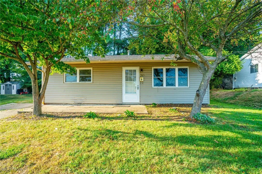 Bungalow with a front yard and a patio