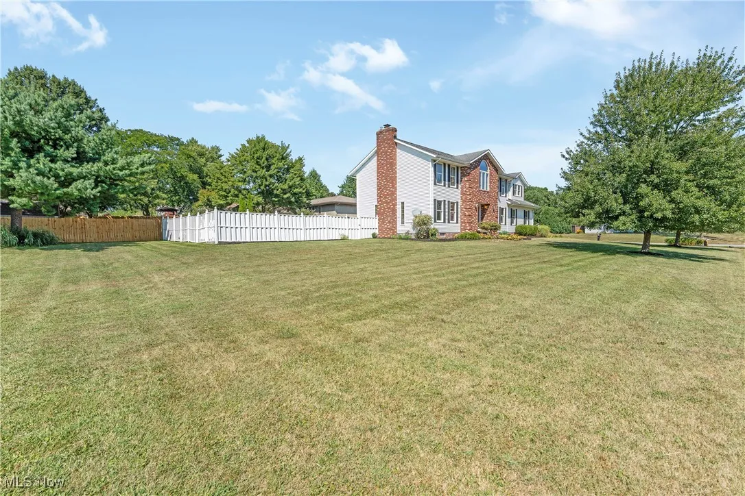 View of yard and vinyl fence