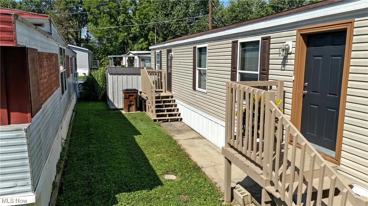 View of side of home featuring a lawn