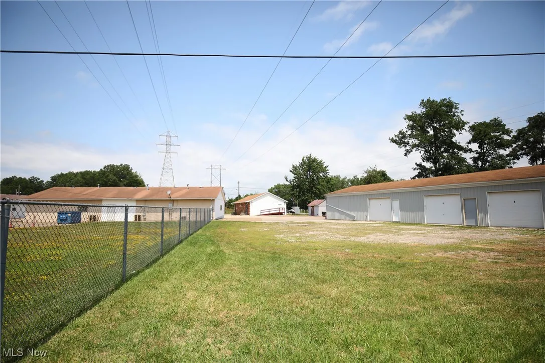 View of yard with a detached garage and an outdoor structure