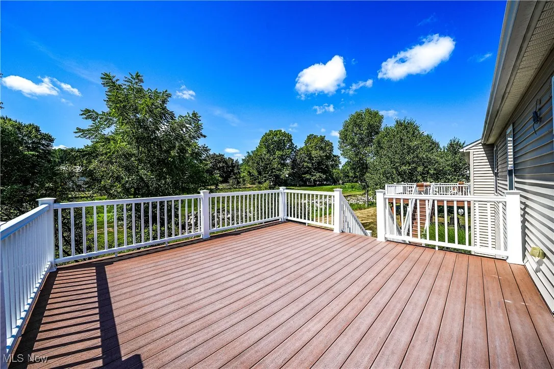 Deck featuring view of scattered trees