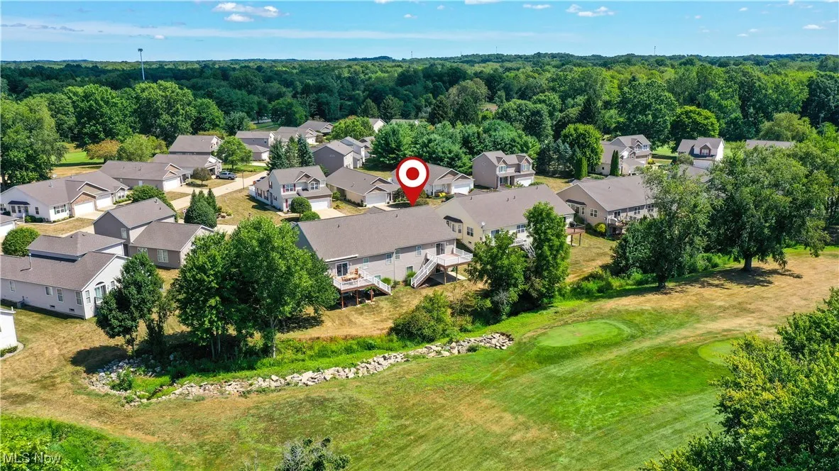 Aerial perspective of suburban area featuring a golf club
