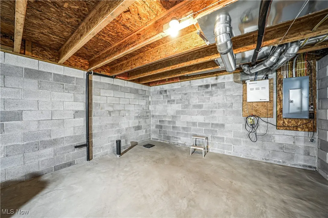Unfinished basement featuring electric panel