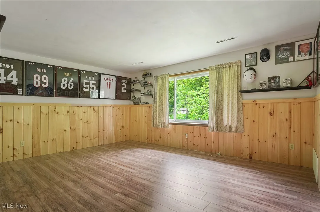 Empty room with wood finished floors and wooden walls